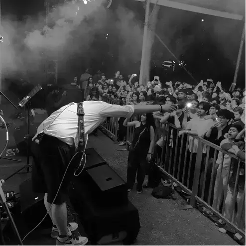 Performer leaning into the crowd at the Mirage fest night stage