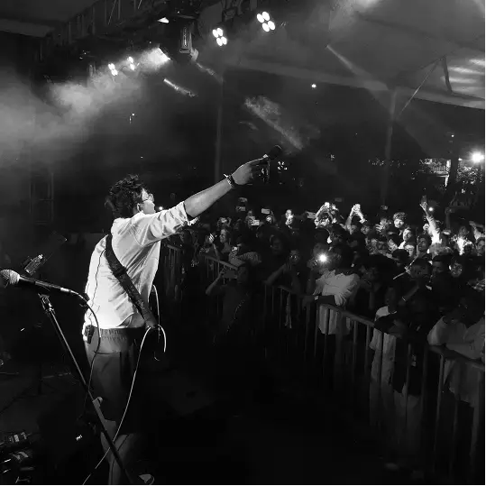 Singer performing under stage lights at Mirage