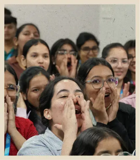 A student with their parents at the “I’m officially a BSTian” photo board
